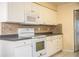 White kitchen with stainless steel appliances and ample cabinet space at 3933 Strickland Ct, Lakeland, FL 33812