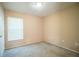 Simple bedroom with carpeted floor, window with blinds, and neutral walls at 3933 Strickland Ct, Lakeland, FL 33812