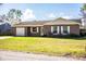 House exterior with a white garage door and front yard at 3933 Strickland Ct, Lakeland, FL 33812