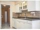Bright kitchen with white cabinets, granite countertops, and built-in breakfast nook at 3933 Strickland Ct, Lakeland, FL 33812