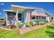 Quaint mobile home exterior with covered porch and colorful landscaping at 5002 Lodgewood Dr, Lakeland, FL 33810