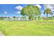 Scenic lakefront view with walking path and lush grass at 5002 Lodgewood Dr, Lakeland, FL 33810