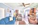 Spacious living room with teal sofas, wood flooring, and ceiling fan at 5002 Lodgewood Dr, Lakeland, FL 33810