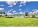 Community clubhouse with manicured lawn and landscaping at 5002 Lodgewood Dr, Lakeland, FL 33810