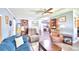 Spacious living room with teal sofas, wood flooring, and ceiling fan at 5002 Lodgewood Dr, Lakeland, FL 33810