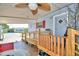 Covered patio with ramp access, ceiling fan, and small table and chairs at 5002 Lodgewood Dr, Lakeland, FL 33810