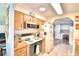 Quaint kitchen with wood cabinets and an electric stove at 5002 Lodgewood Dr, Lakeland, FL 33810