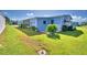 Side view of single-wide manufactured home with patio and landscaping at 5002 Lodgewood Dr, Lakeland, FL 33810