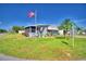 Single-wide manufactured home with screened porch and American flag at 5002 Lodgewood Dr, Lakeland, FL 33810