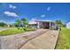 Single-Gathering home with carport and nicely landscaped lawn at 5002 Lodgewood Dr, Lakeland, FL 33810