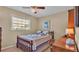 Well-lit bedroom featuring a wooden bed frame and desk at 1175 E George St, Bartow, FL 33830