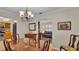 Bright dining room with hardwood floors, a chandelier, and a view into the kitchen at 1175 E George St, Bartow, FL 33830