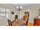 Dining room with wood table, chandelier, and views of kitchen and living room at 1175 E George St, Bartow, FL 33830