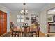 Formal dining room with a wood table, chandelier, and view of the kitchen at 1175 E George St, Bartow, FL 33830