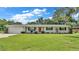 Ranch-style home with brick facade, attached garage, and spacious lawn at 1175 E George St, Bartow, FL 33830