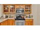 Kitchen boasts stainless steel appliances and wood cabinetry at 1175 E George St, Bartow, FL 33830