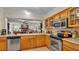 Bright kitchen features stainless steel appliances and light wood cabinets at 1175 E George St, Bartow, FL 33830