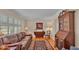 Cozy living room with hardwood floors, a brown leather sofa, and a wooden secretary at 1175 E George St, Bartow, FL 33830