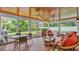 Relaxing screened porch with wicker furniture and brick floor at 1175 E George St, Bartow, FL 33830