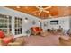 Spacious screened porch, brick floor, wicker furniture, and TV at 1175 E George St, Bartow, FL 33830