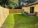 Fenced backyard with patio and grass at 5009 Cimarron Dr, Lakeland, FL 33813