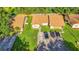 Aerial view of a community of houses with lush green lawns and ample parking at 5009 Cimarron Dr, Lakeland, FL 33813