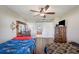 Well-lit bedroom with two twin beds, a dresser, and an ensuite bathroom at 941 Devonshire Way, Lake Wales, FL 33853