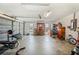 Attached garage with ample space for two vehicles, storage and exercise equipment at 941 Devonshire Way, Lake Wales, FL 33853