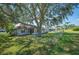 Backyard view of house with mature tree at 941 Devonshire Way, Lake Wales, FL 33853