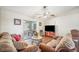 Living room with hardwood floors, comfortable sofas, and access to a lanai at 941 Devonshire Way, Lake Wales, FL 33853