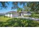 White one-story house with a two-car garage and driveway at 941 Devonshire Way, Lake Wales, FL 33853