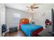 Cozy bedroom with a double bed, ceiling fan, and ample closet space at 941 Devonshire Way, Lake Wales, FL 33853