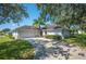 Front view of a single-story house with a palm tree at 941 Devonshire Way, Lake Wales, FL 33853