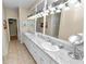 Double vanity bathroom with granite countertops and updated lighting at 2356 Lake James Way, Lakeland, FL 33810