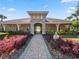 Community clubhouse with stone accents and landscaped walkway at 2356 Lake James Way, Lakeland, FL 33810