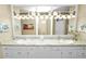 Double vanity bathroom with granite countertops and updated lighting at 2356 Lake James Way, Lakeland, FL 33810