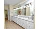 Double vanity bathroom with granite countertops and updated lighting at 2356 Lake James Way, Lakeland, FL 33810