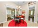 Kitchen nook with breakfast table, red rug, and access to sunroom at 2356 Lake James Way, Lakeland, FL 33810