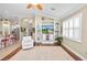Spacious living room featuring hardwood floors, built-in shelving, and a large TV at 2356 Lake James Way, Lakeland, FL 33810