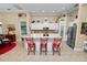 Modern kitchen with white cabinets and red bar stools at 2356 Lake James Way, Lakeland, FL 33810