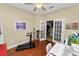 Home office with hardwood floors, a desk, and French doors leading to kitchen at 2356 Lake James Way, Lakeland, FL 33810