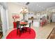 Kitchen with breakfast nook and island, featuring white cabinetry and red accents at 2356 Lake James Way, Lakeland, FL 33810