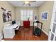 Home office with hardwood floors, a desk, and a treadmill at 2356 Lake James Way, Lakeland, FL 33810