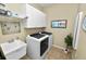 Laundry room with washer, dryer, and utility sink at 2356 Lake James Way, Lakeland, FL 33810