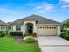 One story house with a two-car garage and manicured lawn at 2356 Lake James Way, Lakeland, FL 33810