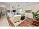 Bright living area with hardwood floors, comfortable seating, and views to the kitchen at 2356 Lake James Way, Lakeland, FL 33810