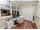 Sunroom office space with hardwood floors, large windows and an office chair at 2356 Lake James Way, Lakeland, FL 33810