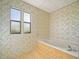 Bathroom with a built-in bathtub and floral wallpaper at 134 Lake Hazel Dr, Winter Haven, FL 33884