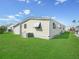Single-wide manufactured home with a well-maintained lawn at 134 Lake Hazel Dr, Winter Haven, FL 33884