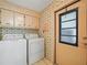 Laundry room with washer, dryer, and built-in cabinets at 134 Lake Hazel Dr, Winter Haven, FL 33884